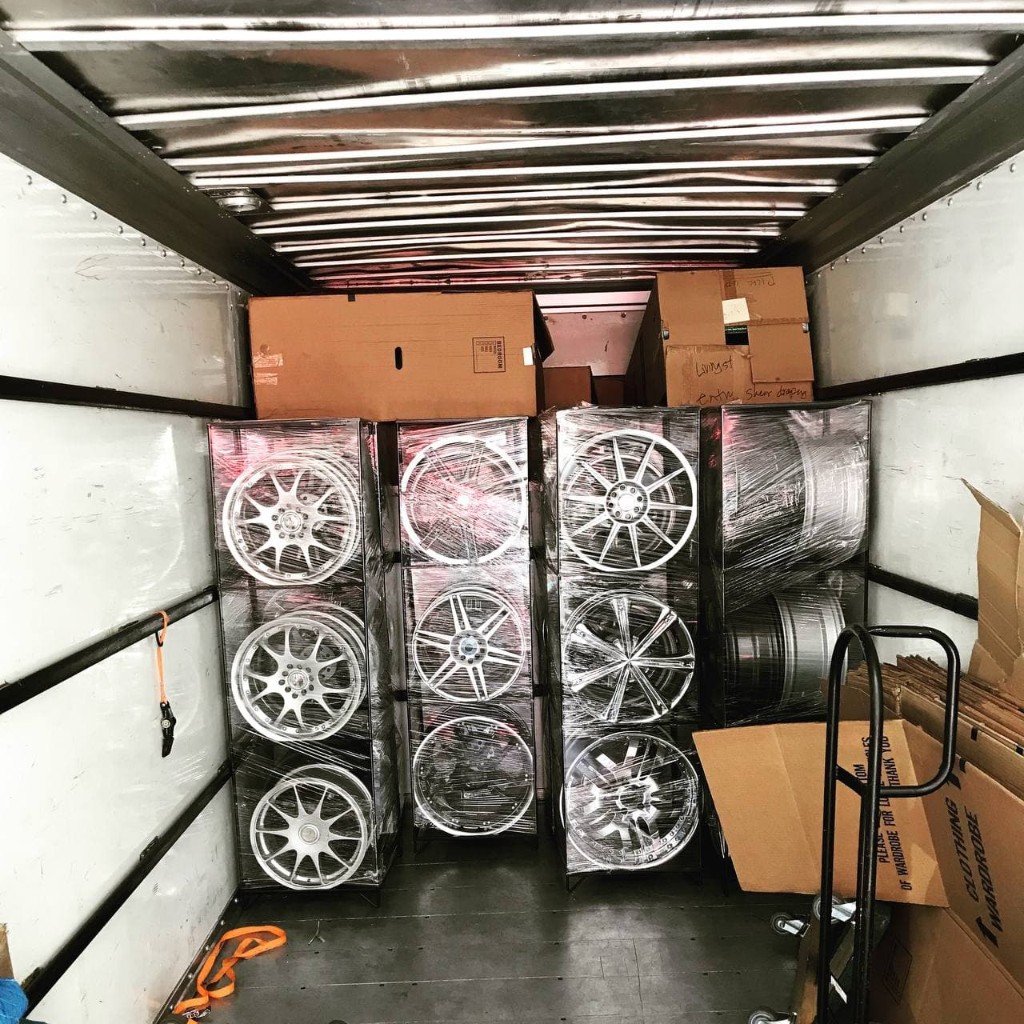 Secured household goods and wheels inside a moving truck