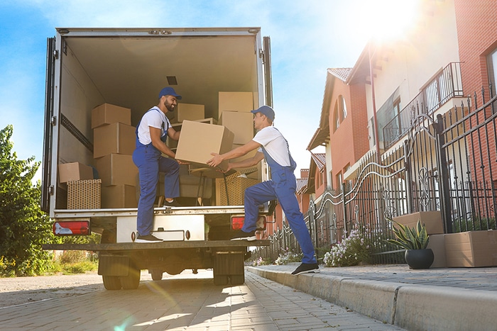 Go Go Agency movers loading a moving truck on a sunny residential street in Southern California